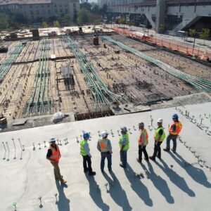 seven construction workers standing on white field contacto